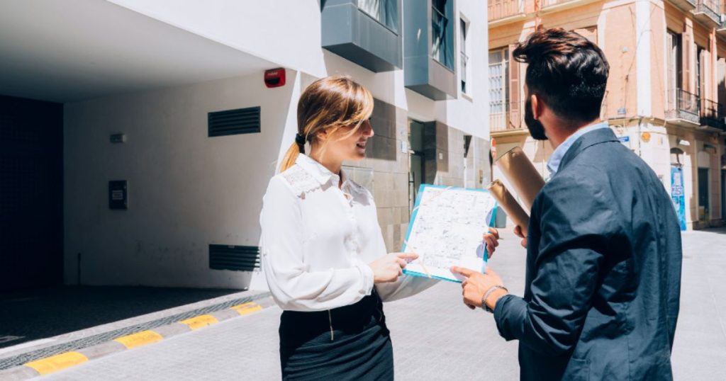 A man looking at apartments with a local real estate expert
